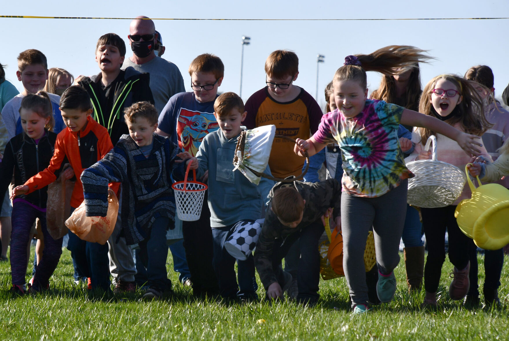 Children sprint toward easter eggs
